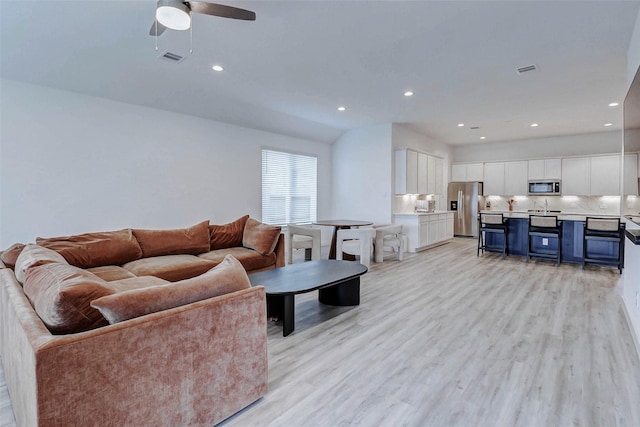 3368 Voda Bend Dr, Katy, TX 77493 - living room with light wood-type flooring, ceiling fan, and recessed lighting