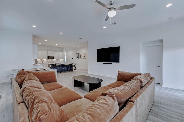 3368 Voda Bend Dr, Katy, TX 77493 - living room with a ceiling fan, light wood finished floors, and recessed lighting