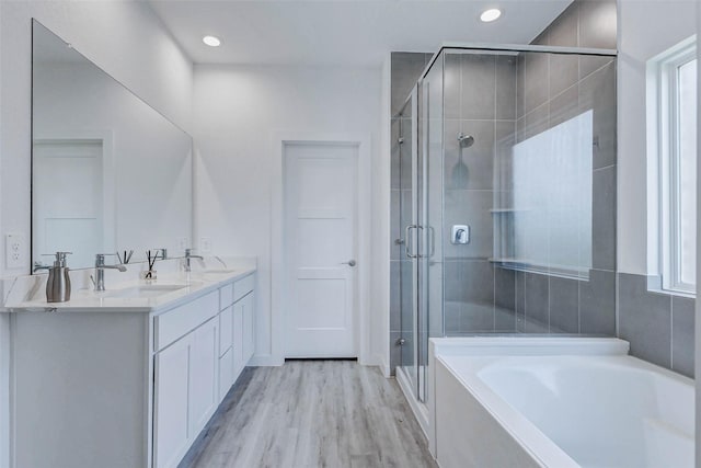 3368 Voda Bend Dr, Katy, TX 77493 - full bath with a garden tub, a shower stall, double vanity, wood finished floors, and recessed lighting