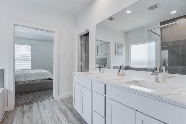 3368 Voda Bend Dr, Katy, TX 77493 - full bath featuring double vanity, wood finished floors, ensuite bath, a stall shower, and recessed lighting