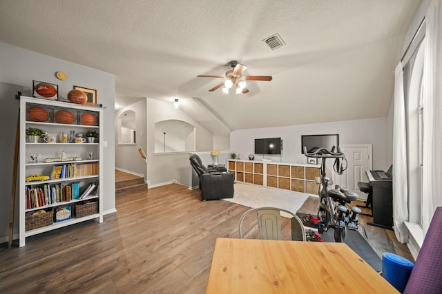 3803 Caleb Ln, Missouri City, TX 77459 - workout area featuring a ceiling fan, lofted ceiling, wood finished floors, and a textured ceiling