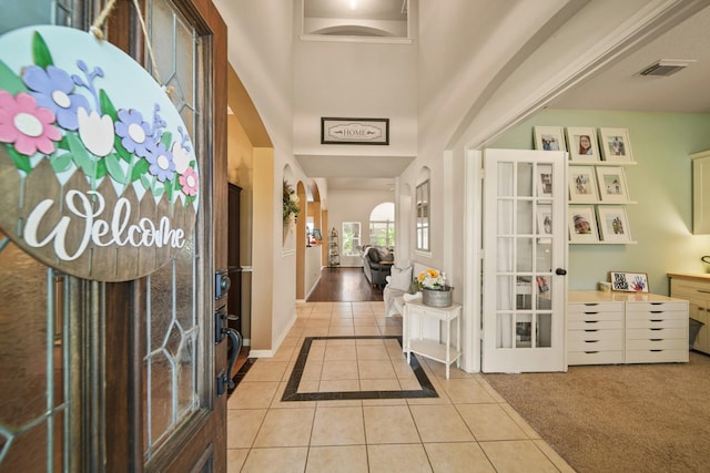 3803 Caleb Ln, Missouri City, TX 77459 - entryway with light tile patterned floors, a towering ceiling, and french doors