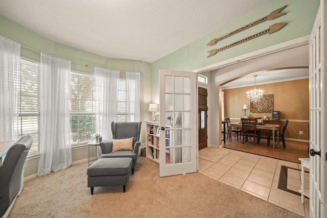 3803 Caleb Ln, Missouri City, TX 77459 - living area featuring french doors, a chandelier, carpet flooring, arched walkways, and tile patterned floors