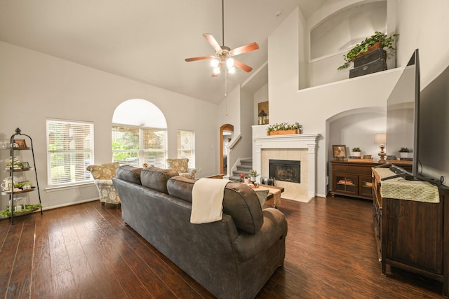 3803 Caleb Ln, Missouri City, TX 77459 - living room featuring high vaulted ceiling, a ceiling fan, arched walkways, dark wood-style flooring, and stairs