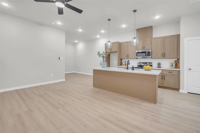 8110 Brandon St, Houston, TX 77051 - kitchen featuring stainless steel appliances, recessed lighting, light wood-type flooring, a ceiling fan, and light countertops