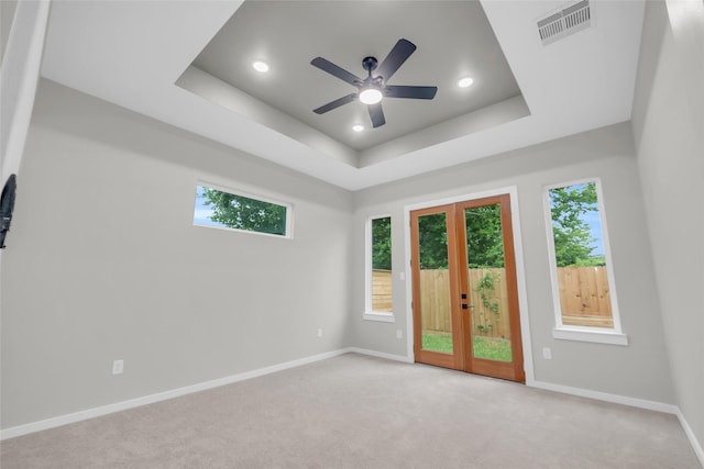 8110 Brandon St, Houston, TX 77051 - unfurnished room featuring ceiling fan, light colored carpet, recessed lighting, a tray ceiling, and french doors