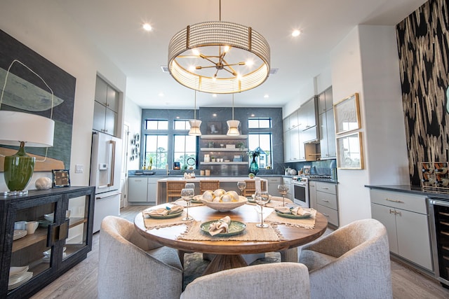 1720 Sedola Ln, Houston, TX 77055 - dining area with light wood-style flooring, a chandelier, wine cooler, and recessed lighting