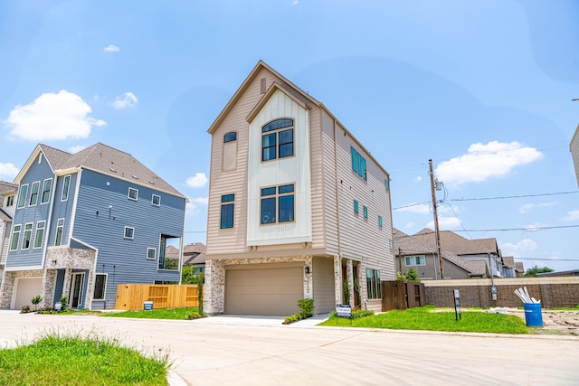 1720 Sedola Ln, Houston, TX 77055 - view of front of house featuring a garage, concrete driveway, and stone siding