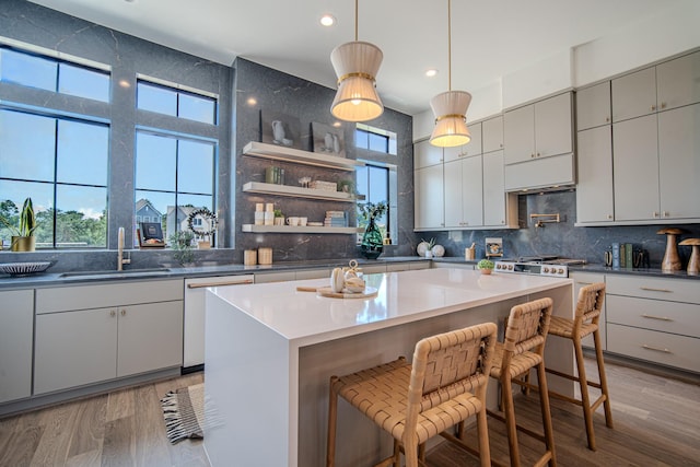 1720 Sedola Ln, Houston, TX 77055 - kitchen with dishwasher, recessed lighting, backsplash, a breakfast bar area, and a center island