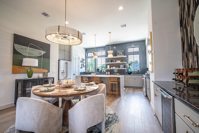 1720 Sedola Ln, Houston, TX 77055 - dining space featuring light wood-type flooring, wine cooler, and recessed lighting