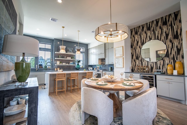 1720 Sedola Ln, Houston, TX 77055 - dining area featuring beverage cooler, light wood-style floors, and recessed lighting