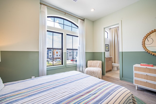 1720 Sedola Ln, Houston, TX 77055 - bedroom with wood finished floors, ensuite bathroom, and recessed lighting