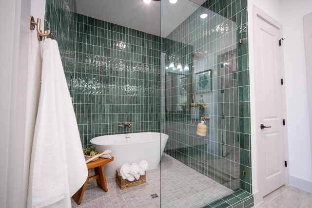 1720 Sedola Ln, Houston, TX 77055 - bathroom featuring a walk in shower, a freestanding tub, and tile patterned flooring