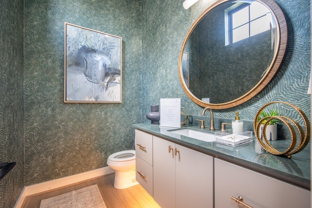 1720 Sedola Ln, Houston, TX 77055 - bathroom with wood finished floors, wallpapered walls, and vanity