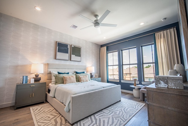 1720 Sedola Ln, Houston, TX 77055 - bedroom featuring wood finished floors, wallpapered walls, recessed lighting, and ceiling fan