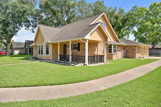 2101 Rocky Creek Ln, Pearland, TX 77581 - ranch-style home with a front lawn, covered porch, roof with shingles, and brick siding