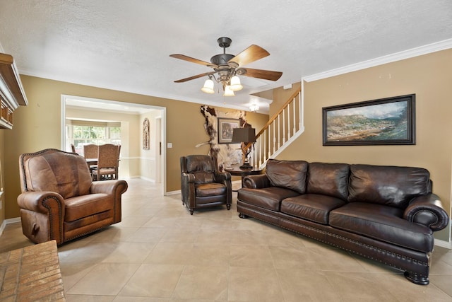 2101 Rocky Creek Ln, Pearland, TX 77581 - living area with a ceiling fan, stairs, a textured ceiling, light tile patterned floors, and crown molding