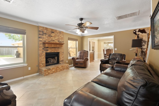 2101 Rocky Creek Ln, Pearland, TX 77581 - living area with a ceiling fan, a textured ceiling, healthy amount of natural light, light tile patterned floors, and a brick fireplace