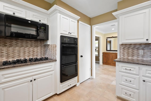 2101 Rocky Creek Ln, Pearland, TX 77581 - kitchen with black appliances, white cabinetry, backsplash, and dark stone counters