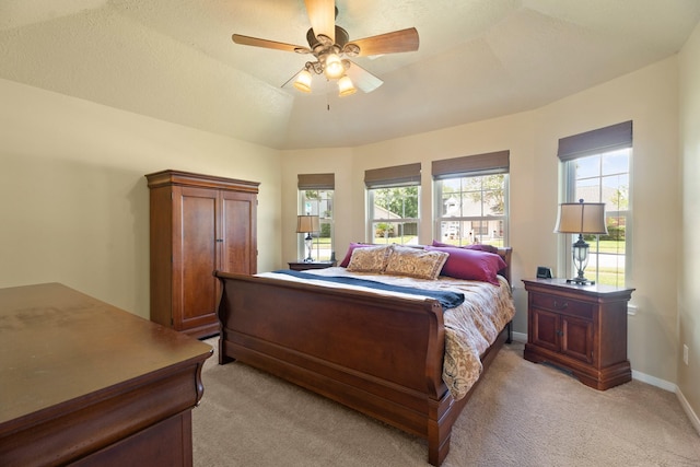 2101 Rocky Creek Ln, Pearland, TX 77581 - bedroom with light colored carpet, multiple windows, and ceiling fan