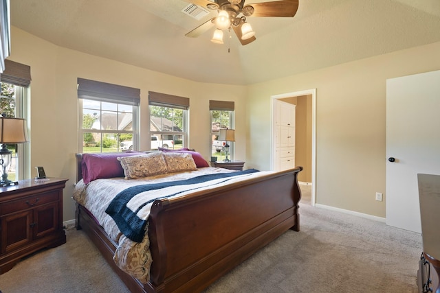 2101 Rocky Creek Ln, Pearland, TX 77581 - bedroom with light colored carpet, multiple windows, ensuite bath, and ceiling fan