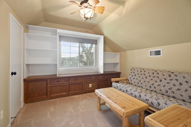 2101 Rocky Creek Ln, Pearland, TX 77581 - living room featuring vaulted ceiling, a textured ceiling, light carpet, and a ceiling fan