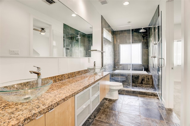 2232 Leeland St, Houston, TX 77003 - full bath with a stall shower, tiled tub, double vanity, recessed lighting, and stone finish flooring