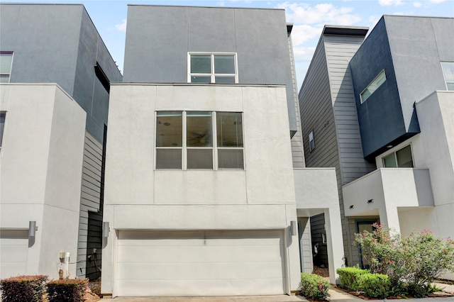 2232 Leeland St, Houston, TX 77003 - modern home with an attached garage, driveway, and stucco siding
