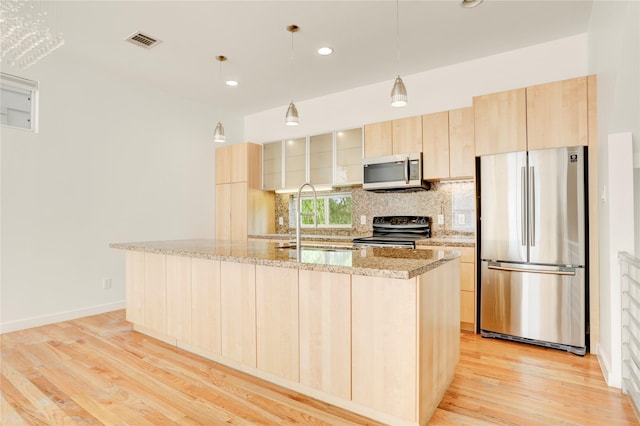 2232 Leeland St, Houston, TX 77003 - kitchen with appliances with stainless steel finishes, light brown cabinets, decorative backsplash, light wood-type flooring, and recessed lighting
