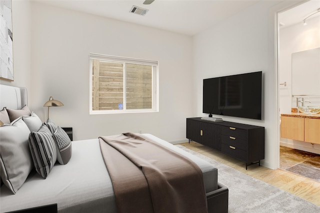 2232 Leeland St, Houston, TX 77003 - bedroom with light wood finished floors and ensuite bathroom