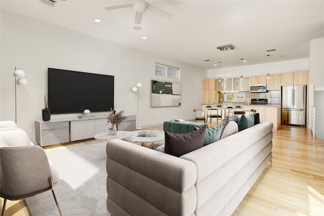 2232 Leeland St, Houston, TX 77003 - living room featuring light wood-style floors, a ceiling fan, and recessed lighting