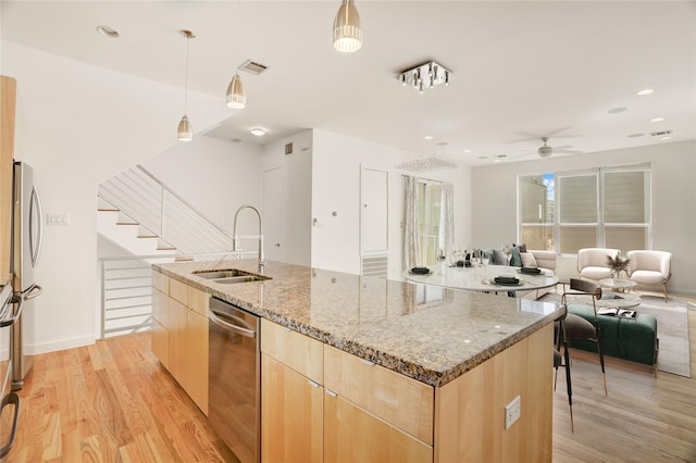 2232 Leeland St, Houston, TX 77003 - kitchen featuring light brown cabinetry, appliances with stainless steel finishes, open floor plan, a ceiling fan, and modern cabinets