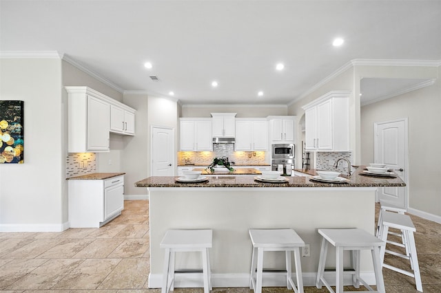 27910 Wedgeoak Ct, Katy, TX 77494 - kitchen featuring stainless steel appliances, decorative backsplash, under cabinet range hood, dark stone countertops, and recessed lighting