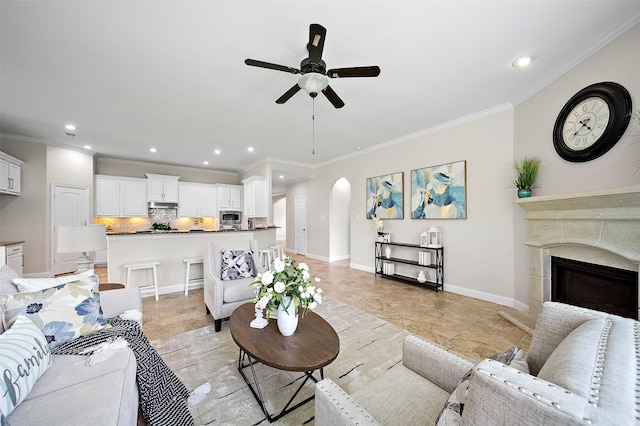 27910 Wedgeoak Ct, Katy, TX 77494 - living area with ceiling fan, arched walkways, crown molding, recessed lighting, and a high end fireplace
