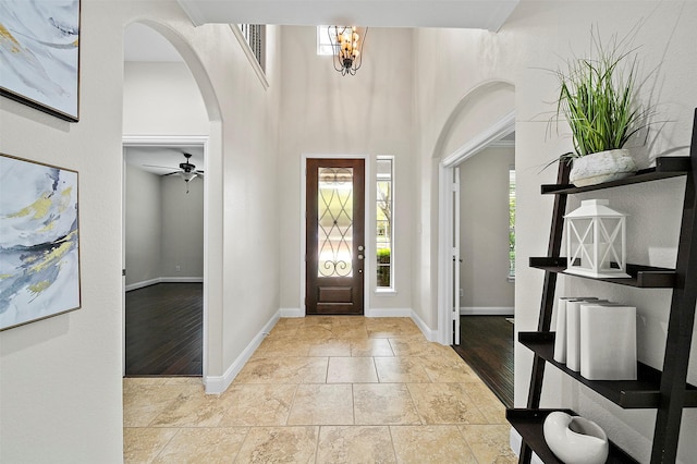 27910 Wedgeoak Ct, Katy, TX 77494 - foyer entrance with arched walkways, stone finish flooring, and ceiling fan
