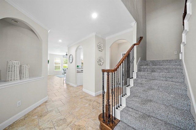 27910 Wedgeoak Ct, Katy, TX 77494 - staircase featuring arched walkways, stone tile floors, ornamental molding, and recessed lighting