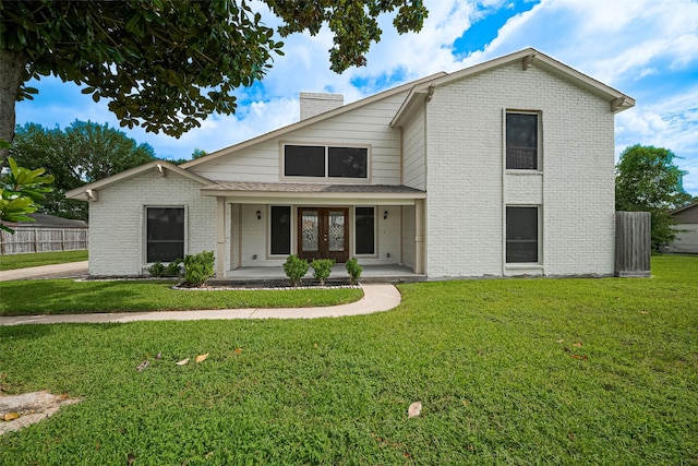 982 W Donovan St, Houston, TX 77091 - view of front of property with brick siding, french doors, a front lawn, and a chimney