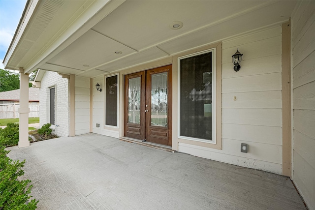 982 W Donovan St, Houston, TX 77091 - doorway to property featuring french doors, brick siding, and a patio area