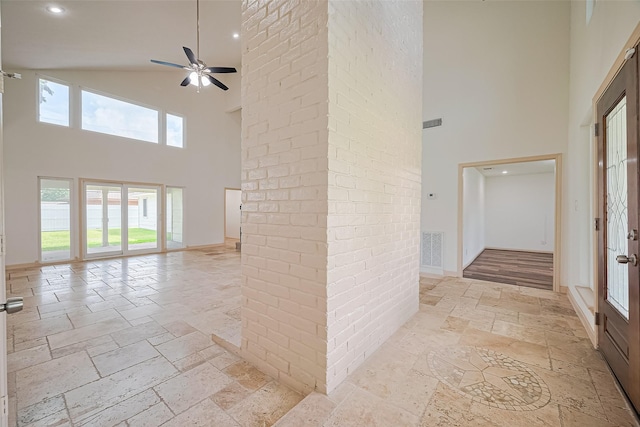 982 W Donovan St, Houston, TX 77091 - hall featuring high vaulted ceiling, stone tile floors, and recessed lighting