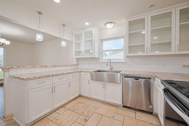982 W Donovan St, Houston, TX 77091 - kitchen with stainless steel appliances, a peninsula, stone tile floors, white cabinets, and recessed lighting