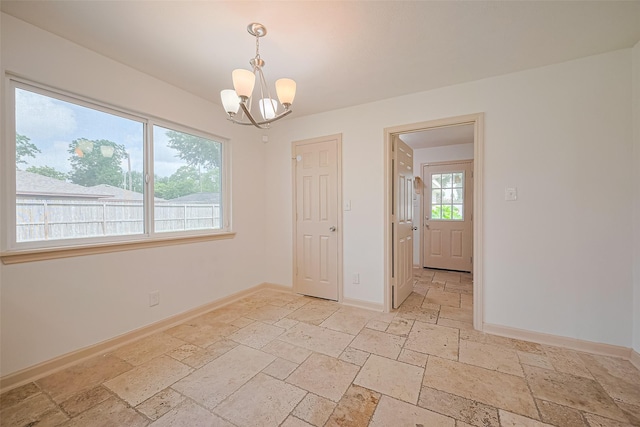 982 W Donovan St, Houston, TX 77091 - unfurnished room featuring stone tile flooring and a chandelier