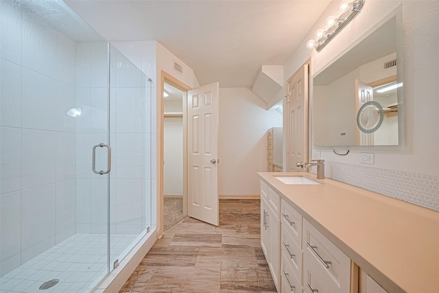 982 W Donovan St, Houston, TX 77091 - bathroom featuring a stall shower, vanity, a walk in closet, and marble finish flooring