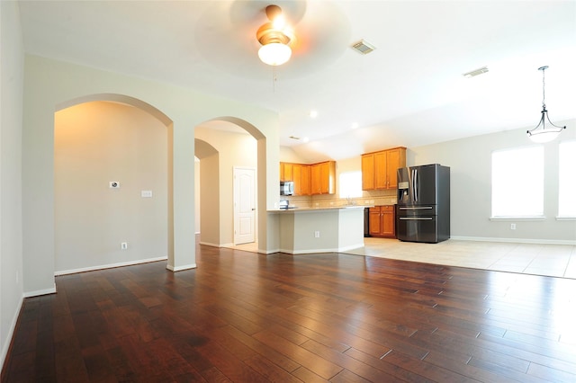 8022 Thorncroft Manor Ln, Richmond, TX 77407 - unfurnished living room with ceiling fan, light wood-style floors, arched walkways, and vaulted ceiling