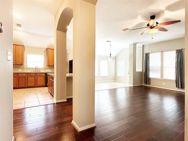 8022 Thorncroft Manor Ln, Richmond, TX 77407 - unfurnished room with ceiling fan, healthy amount of natural light, lofted ceiling, wood-type flooring, and arched walkways