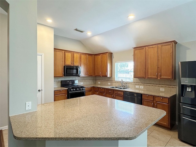 8022 Thorncroft Manor Ln, Richmond, TX 77407 - kitchen with gas stove, dishwasher, black microwave, fridge with ice dispenser, and brown cabinetry