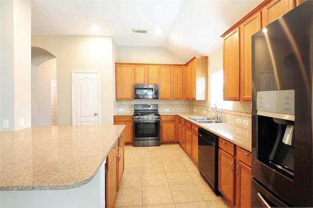 8022 Thorncroft Manor Ln, Richmond, TX 77407 - kitchen featuring stainless steel appliances, light stone counters, decorative backsplash, light tile patterned floors, and vaulted ceiling