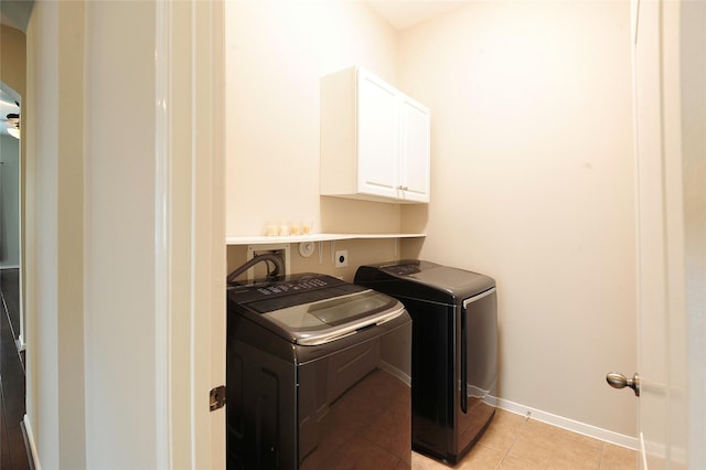 8022 Thorncroft Manor Ln, Richmond, TX 77407 - laundry room featuring cabinet space, washer and dryer, and light tile patterned floors
