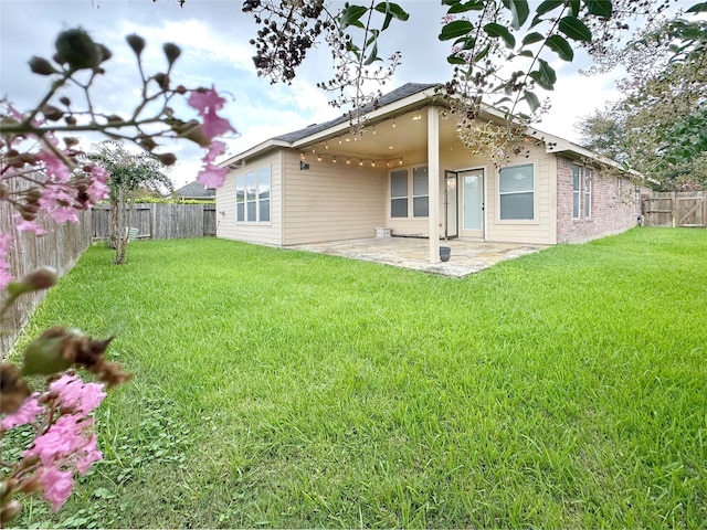 8022 Thorncroft Manor Ln, Richmond, TX 77407 - rear view of house with a fenced backyard, a patio area, and brick siding