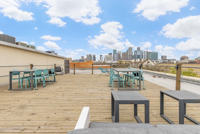 1312 Live Oak St Unit 215, Houston, TX 77003 - wooden terrace featuring a view of skyline and outdoor dining space