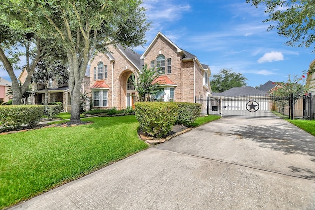 15510 Marble Canyon Way, Houston, TX 77044 - traditional-style home featuring a gate, brick siding, and driveway